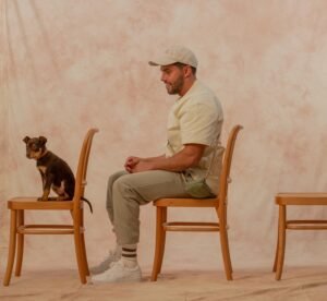 Dog and dog trainer sitting on chairs