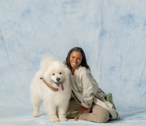 Dog owner hugging her Samoyed dog